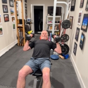 Mark Neese lifting weights in his home gym. Photo for a True North Counseling blog post on Bernarr McFadden.