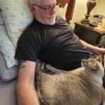 Mark Neese with his cat, Hansel.